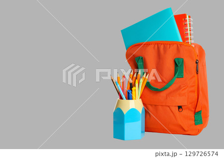 Backpack filled with notebooks and colorful pencils for students 129726574