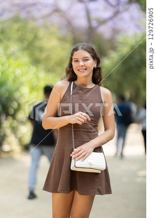 Woman walking in the park in summer 129726905