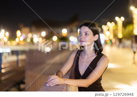 At night, smiling girl walks around old city district Barceloneta, in vicinage of Citadel Park At night, smiling girl walks around old city district Barceloneta, in vicinage of Citadel Park 129726948