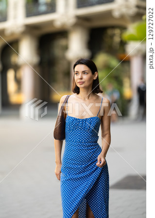 Young woman posing on city street Young woman posing on city street 129727022