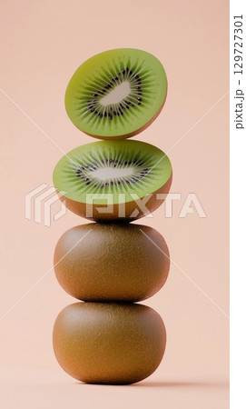A stack of kiwi fruit balancing on top with pink solid background 129727301