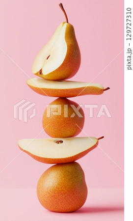 A stack of pear slice fruit balancing on top with solid background 129727310
