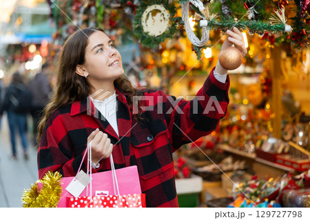 Girl shopping at festive fair before Xmas Girl shopping at festive fair before Xmas 129727798