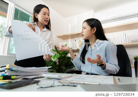 Conflict Resolution. Employee confronted by manager over performance issues in the office. 129728034