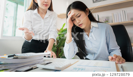 Workplace Stress. Employee experiencing anxiety during a tense meeting with manager. 129728079