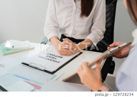 Financial Planning. Professional woman reviewing a financial report in the office. 129728234