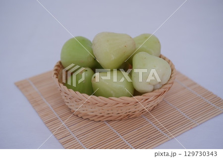 Fresh Rose Apples in a Woven Basket 129730343