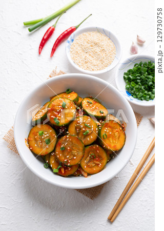 Korean cucumber salad (Oi muchim) in bowl on white background, Korean side dish Korean cucumber salad (Oi muchim) in bowl on white background, Korean side dish 129730758