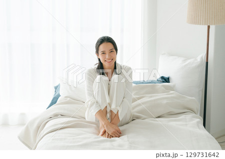 起床するパジャマ姿の女性 129731642