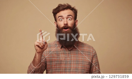surprised man with beard pointing upward 129731859