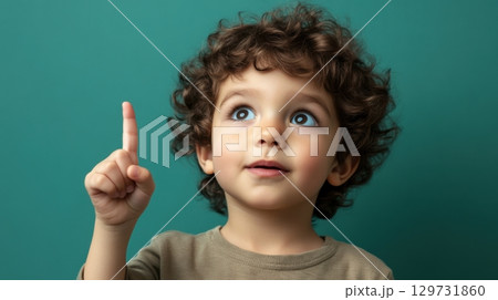 curious toddler boy pointing upward 129731860