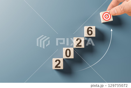 Hand putting wooden block with target icon to complete 2026 stair, representing business growth, success and achieving goals concept Hand putting wooden block with target icon to complete 2026 stair, representing business growth, success and achieving goals concept 129735072