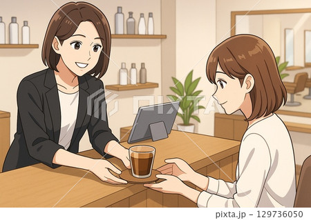 美容室の受付でお客様にドリンクを提供するスタッフ 129736050