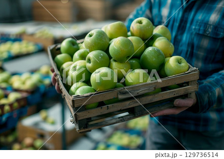 A man is holding a basket of green apples. ai generative 129736514