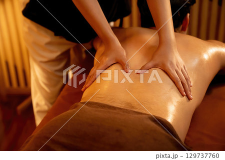Caucasian man customer enjoying relaxing anti-stress massage. Quiescent Caucasian man customer enjoying relaxing anti-stress massage. Quiescent 129737760