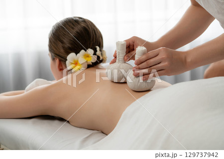 Hot herbal ball spa massage body treatment at day spa . Quiescent Hot herbal ball spa massage body treatment at day spa . Quiescent 129737942