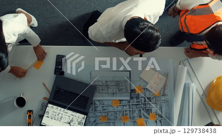 Top view of smart team working together while standing at table. Alimentation. 129738438