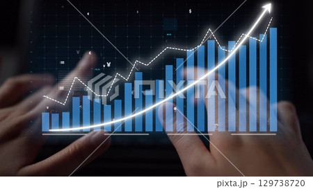 Hands on a Keyboard Analyzing a Financial Graph with Rising Trends and Data Points on a Digital Screen Representing Market Growth and Success Copula 129738720