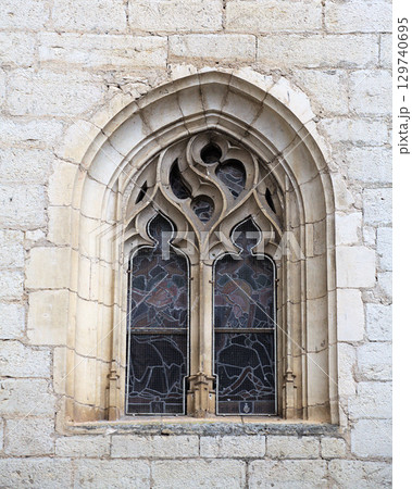 Gothic window detail in Rocamadour, France, showcasing intricate design and historical architecture 129740695