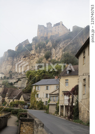 Picturesque Beynac-et-Cazenac village in France shrouded in morning fog Picturesque Beynac-et-Cazenac village in France shrouded in morning fog 129740763