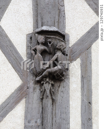 Carved relief sculpture on a building in Blois, France depicting intricate human figures 129740931