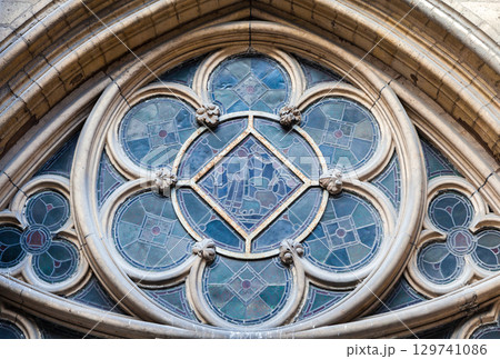 Stained glass window at Sainte-Chapelle showcasing intricate design, exterior Stained glass window at Sainte-Chapelle showcasing intricate design, exterior 129741086