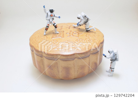 Miniature Astronauts Exploring a Mooncake in Whimsical Conceptual Art 129742204