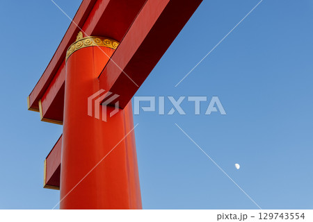 Red torii pillar with golden crest and moon in Kyoto sky Red torii pillar with golden crest and moon in Kyoto sky 129743554