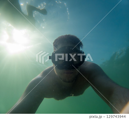 Happy Snorkeler Underwater taking Selfie 129743944