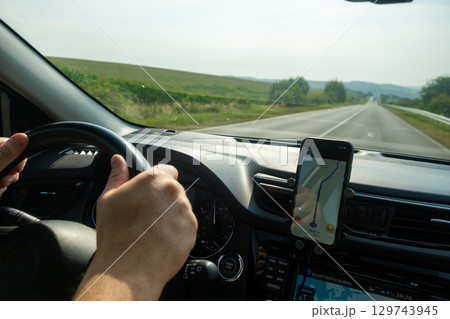 Driving with GPS Navigation on a Rural Road 129743945