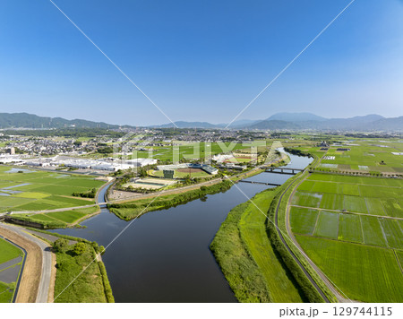 ドローン空撮した小郡市陸上競技場、野球場、川と水田 ドローン空撮した小郡市陸上競技場、野球場、川と水田 129744115