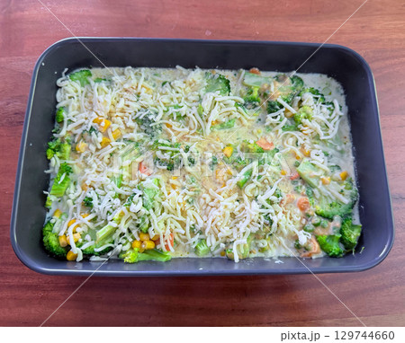 Loaded vegetable casserole with broccoli, cauliflower and leek. Top view, space for text Loaded vegetable casserole with broccoli, cauliflower and leek. Top view, space for text 129744660