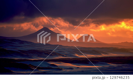 Sunrise unveils majestic mountain silhouettes Sunrise unveils majestic mountain silhouettes 129746235