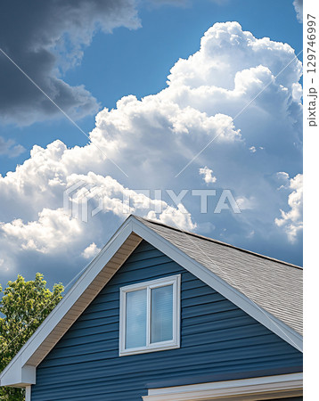 House gable under blue cloud sky. AI Generated. 129746997