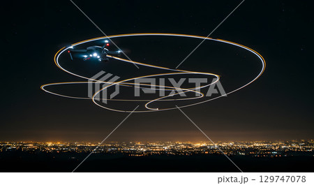 Drone flying at night with light trails over cityscape glowing warmly Drone flying at night with light trails over cityscape glowing warmly 129747078