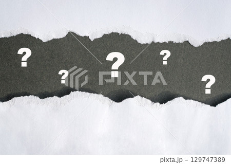 Question mark signs on darak gray and white paper background. Question mark signs on darak gray and white paper background. 129747389