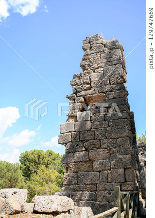 Ancient stone tower ruins in Phaselis Ancient City, Turkey 129747669