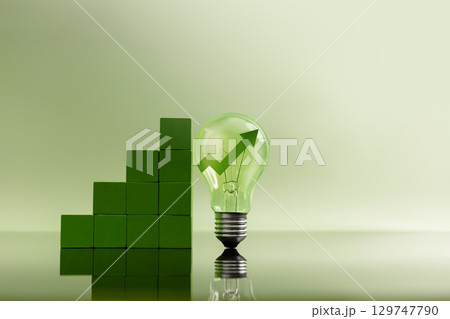 Green financial chart leads up to a glowing light bulb, Smart investment, innovation, and economic growth through insightful decision making 129747790