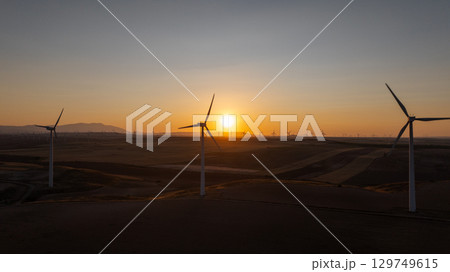 Wind turbines generating sustainable energy during a vibrant sunset in pedrola, zaragoza, Aragon, Spain, showcasing renewable energy production Wind turbines generating sustainable energy during a vibrant sunset in pedrola, zaragoza, Aragon, Spain, showcasing renewable energy production 129749615