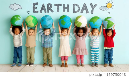 Children celebrate Earth Day by holding colorful globe models under a cheerful backdrop 129750048