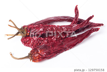 Dried red peppers on white background Dried red peppers on white background 129750158