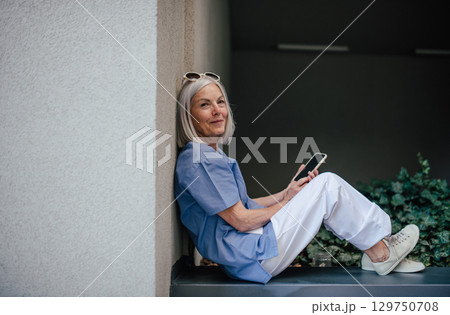 Older nurse resting during hospital shift, taking break. Older nurse resting during hospital shift, taking break. 129750708