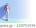 a woman standing against a wall 129753339