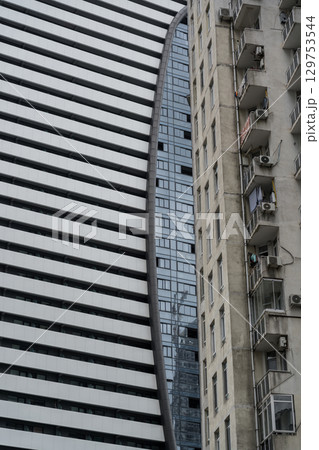 New high-rise building on the background of an old building 129753544