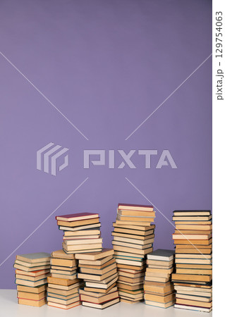 Stacks of educational books to study in the library as the background of the university 129754063