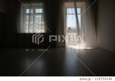Interior of an empty room with a window and a door 129754246