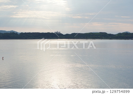 朝の浜名湖に差し込む柔らかな光 静けさに包まれた水面風景 朝の浜名湖に差し込む柔らかな光 静けさに包まれた水面風景 129754899
