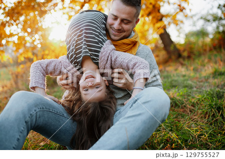 Father and young girl on walk in autumn nature, spending sunday outdoors. Father and young girl on walk in autumn nature, spending sunday outdoors. 129755527