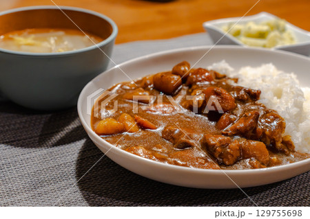 鶏肉やじゃがいも、にんじんが入った家庭的なカレーライスの夕食 129755698