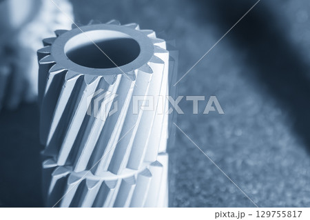 Close up scene small gear shape part from laser sintering method in the blue tone scene. 129755817
